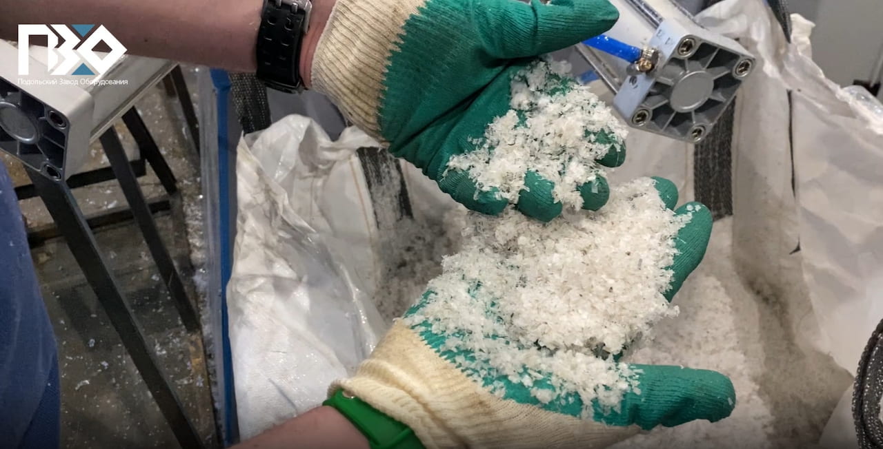 Готовый агломерат из плёнки в руках рабочего.